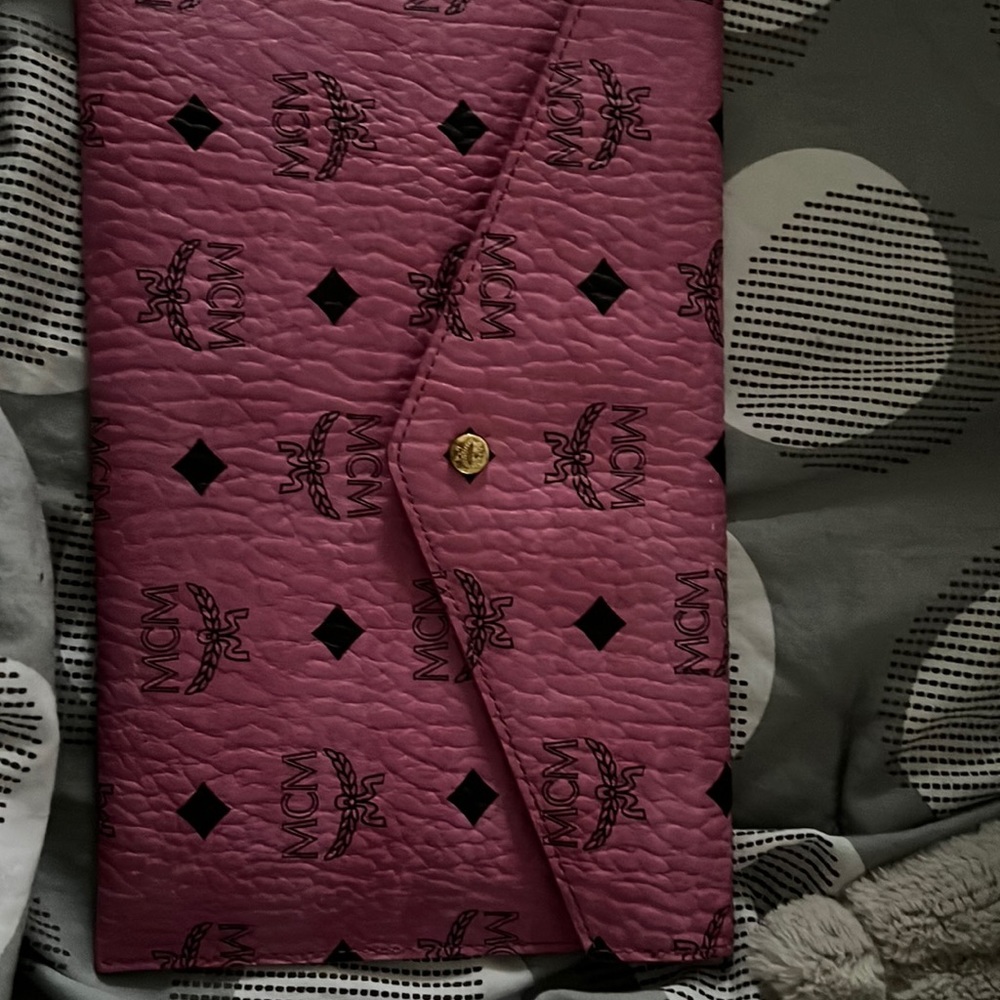 A pink small MCM clutch